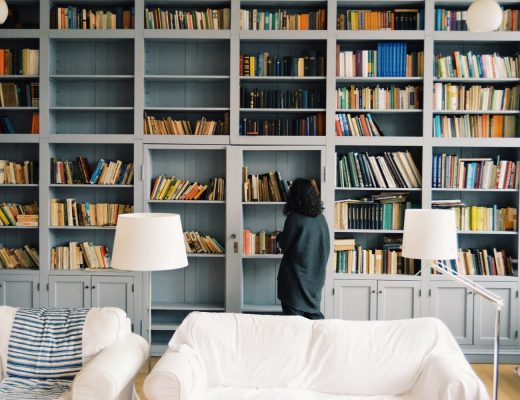 Woman standing in front of book shelf