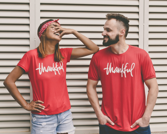 couple wearing red thankful t-shirts