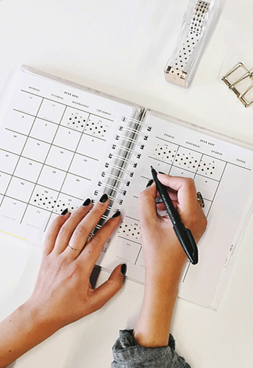 woman writing in calendar