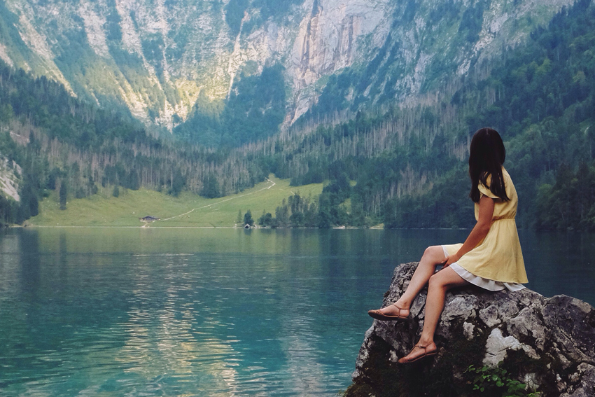 woman sitting on rock