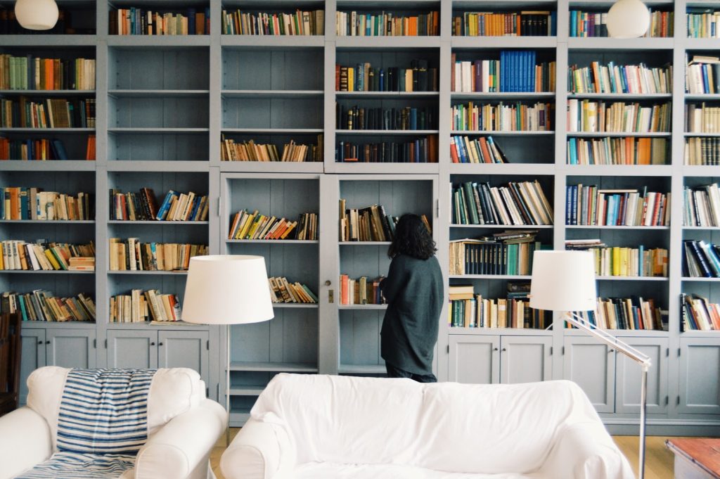 Woman standing in front of book shelf