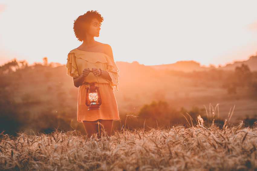 The Most Overlooked Key to Happiness | Woman holding a lantern at dusk