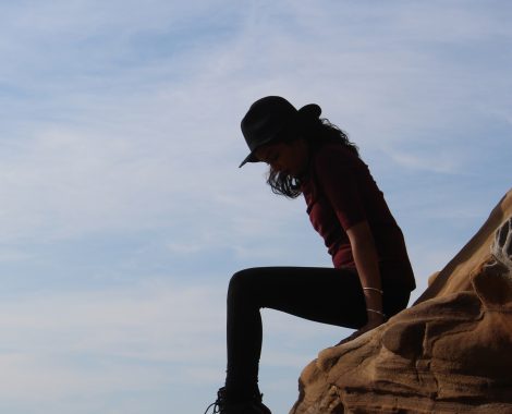 woman sitting on rock